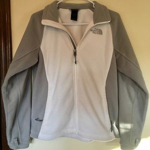 White and grey north face zip up jacket